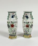 A pair of Chinese famille rose porcelain baluster vases, of faceted baluster form, with chilong