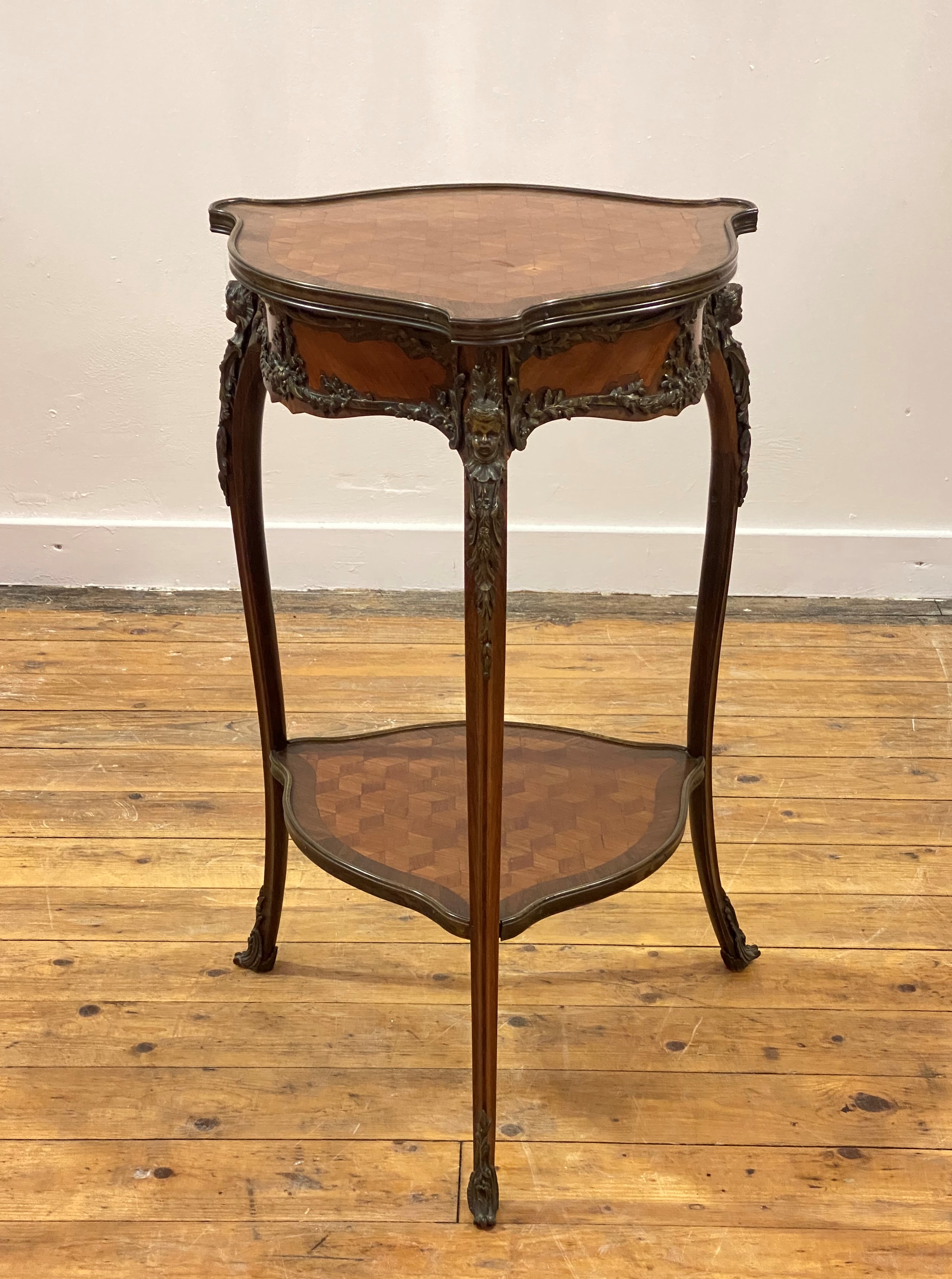 A kingwood and rosewood triform side table in the Louis XV taste, late 19th century, the cross