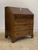 An Edwardian mahogany bureau, the fall front revealing fitted interior over four graduated drawer,