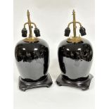 A pair of famille noir ginger jar style vase lamps with adjustable brass twin light fitting
