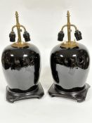 A pair of famille noir ginger jar style vase lamps with adjustable brass twin light fitting