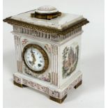 A French 19thc faience mantel clock with moulded top and ormolu mounted circular faience panel