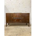 A 1930's mahogany sideboard of Georgian design, three centre drawers flanked by two cupboards,