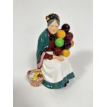 A Royal Doulton figure, The Old Balloon Seller, HN1315, decorated with polychrome enamels (20cm x