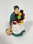 A Royal Doulton figure, The Old Balloon Seller, HN1315, decorated with polychrome enamels (20cm x