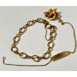 An oval link bracelet with clip fastening (d.9cm), complete with safety chain, a 9ct gold pierced