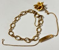 An oval link bracelet with clip fastening (d.9cm), complete with safety chain, a 9ct gold pierced