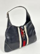 A vintage Gucci blue leather crescent shaped shoulder bag with adjustable strap and a lobster claw