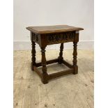 An 18th century style oak Joint stool, with floral carved frieze, turned and block supports,