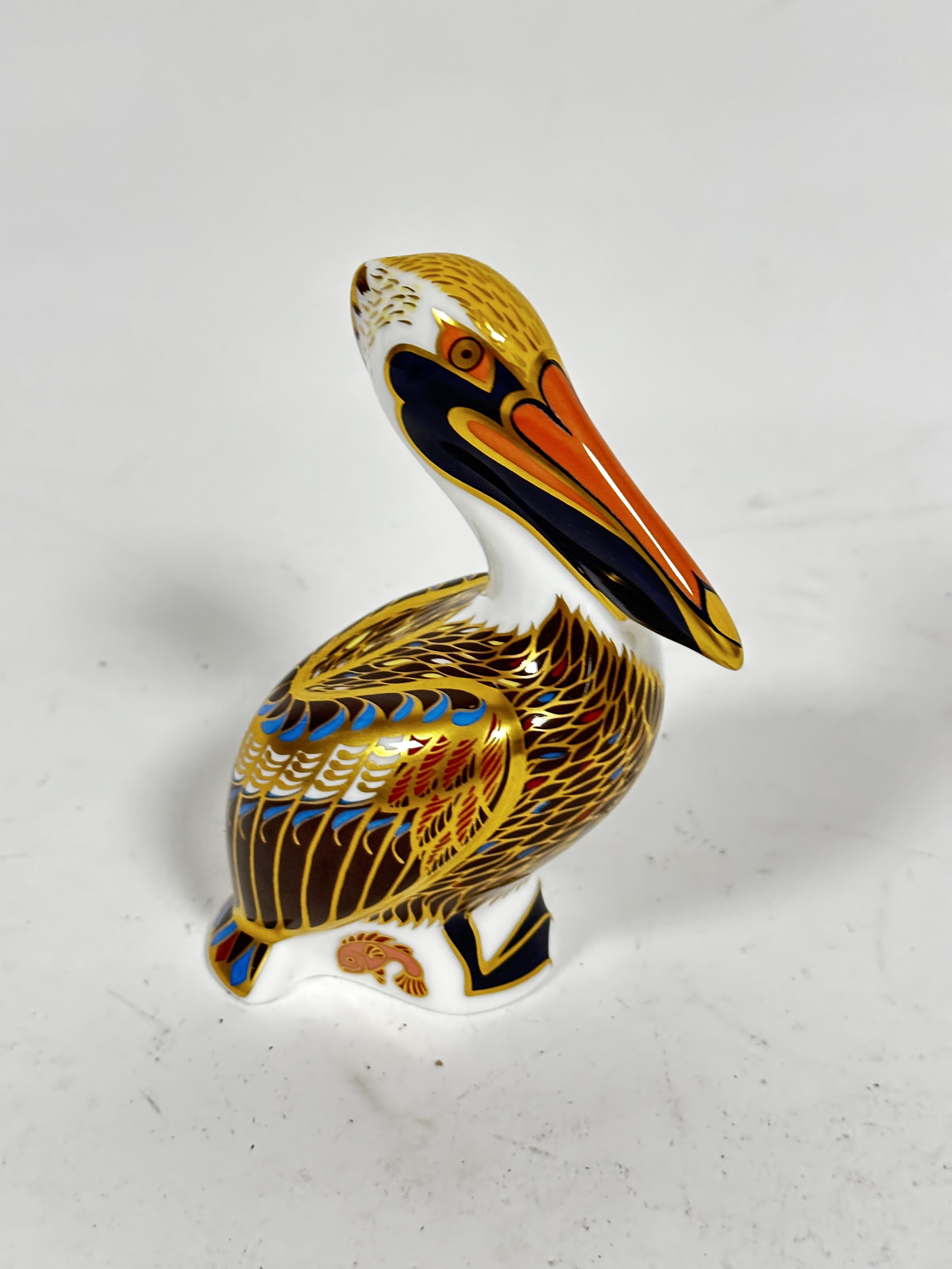 A Royal Crown Derby paperweight figure of a brown Pelican 1998, decorated with pink, blue, brown and