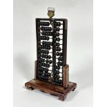 A stained Chinese upright abacus framed table lamp, the abacus of earlier origin with metal straps