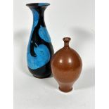 A hand thrown flared rim baluster vase with turquoise blue and dark blue glazed abstract design (h.