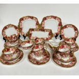 A Royal Albert pink rose and gilt bordered teaset of thirty nine pieces, including two cake