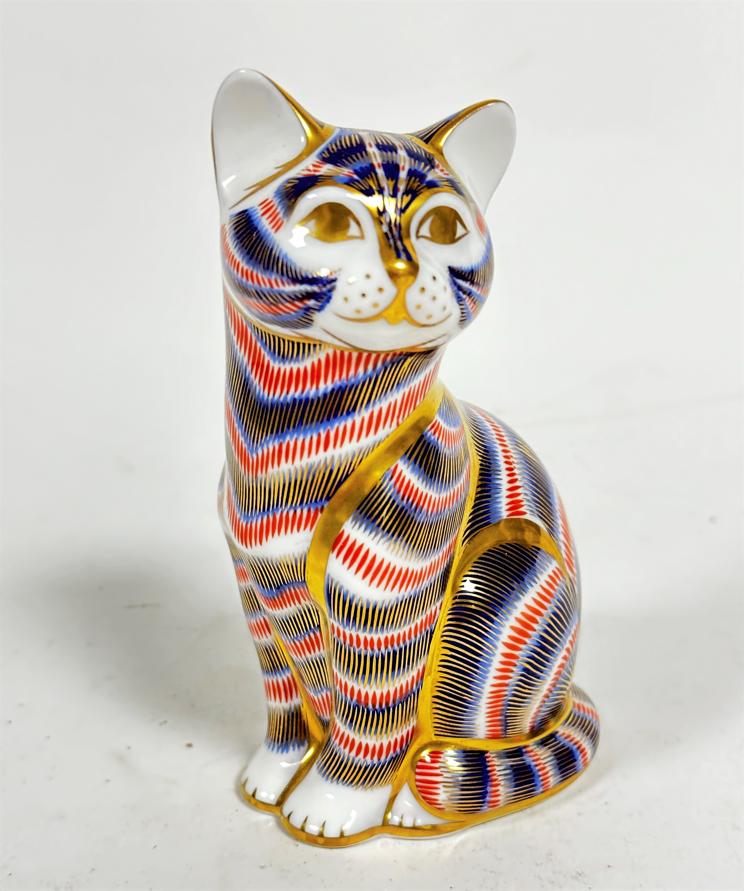 A Royal Crown Derby seated tabby cat paperweight decorated with Pattern 25, (12.5cm x 8cm x 5cm)