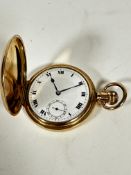 A gilt metal full hunter pocket watch with engraved initials AJM with enamelled dial and