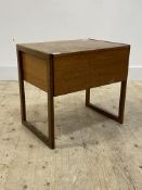 A mid century teak sewing table, the lid lifting to reveal a quantity of sewing threads, ribbon,