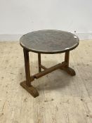 An Eastern style carved hardwood folding lamp table, the circular top with plate glass over carved