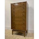 A mid century walnut veneered chest, fitted with seven graduated drawers, square tapered supports,