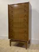 A mid century walnut veneered chest, fitted with seven graduated drawers, square tapered supports,