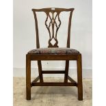A George III country elm chair, splat back over drop in seat pad, raised on square moulded supports,