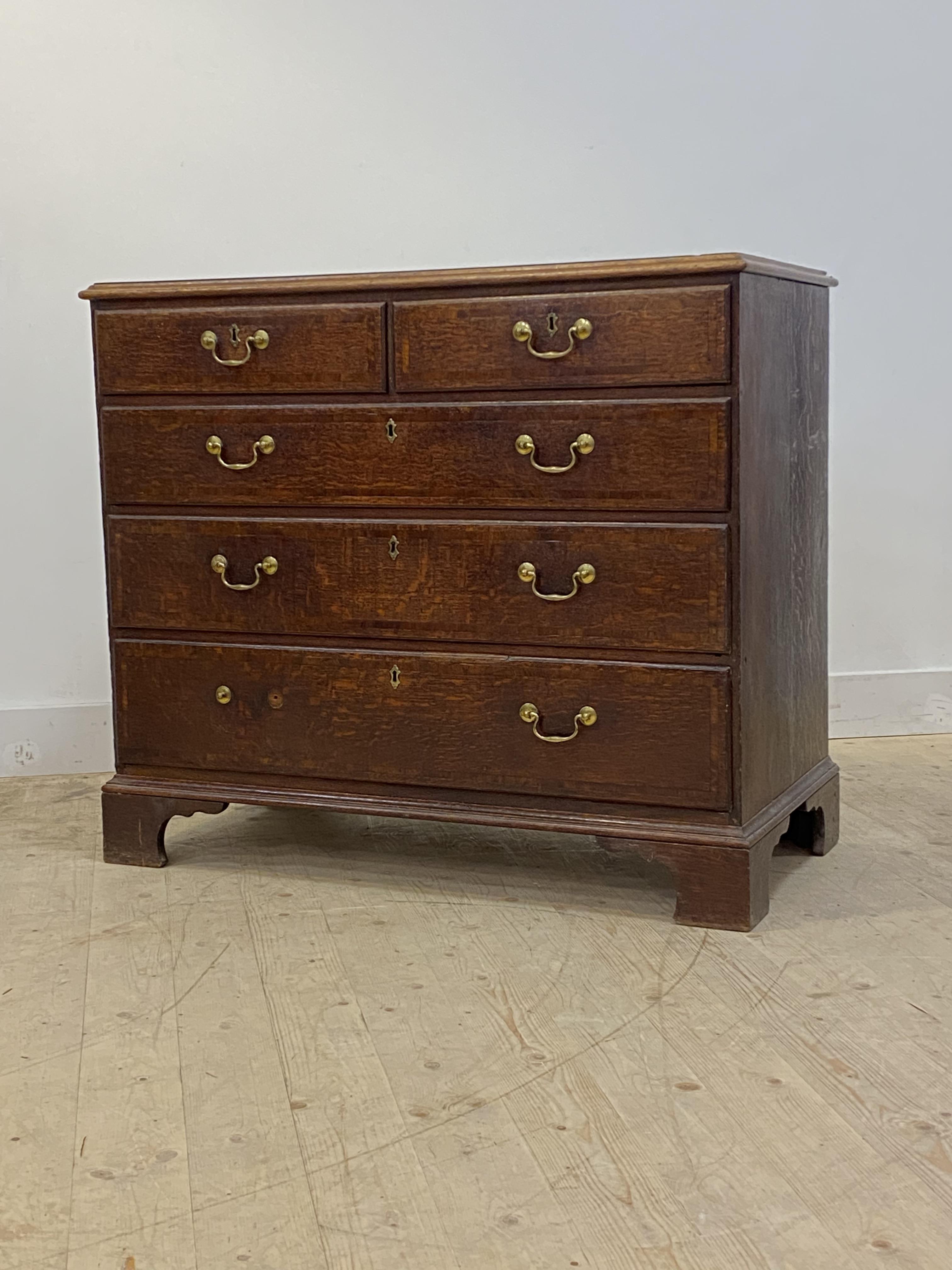 A George III oak chest, mahogany cross banded top and two short and three long graduated drawers, - Image 2 of 4