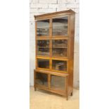 An oak stacking library bookcase, first half of the 20th century, four sections each with two glazed