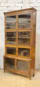 An oak stacking library bookcase, first half of the 20th century, four sections each with two glazed