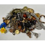A collection of costume jewellery including bead necklaces, paste brooches, paste set yellow metal