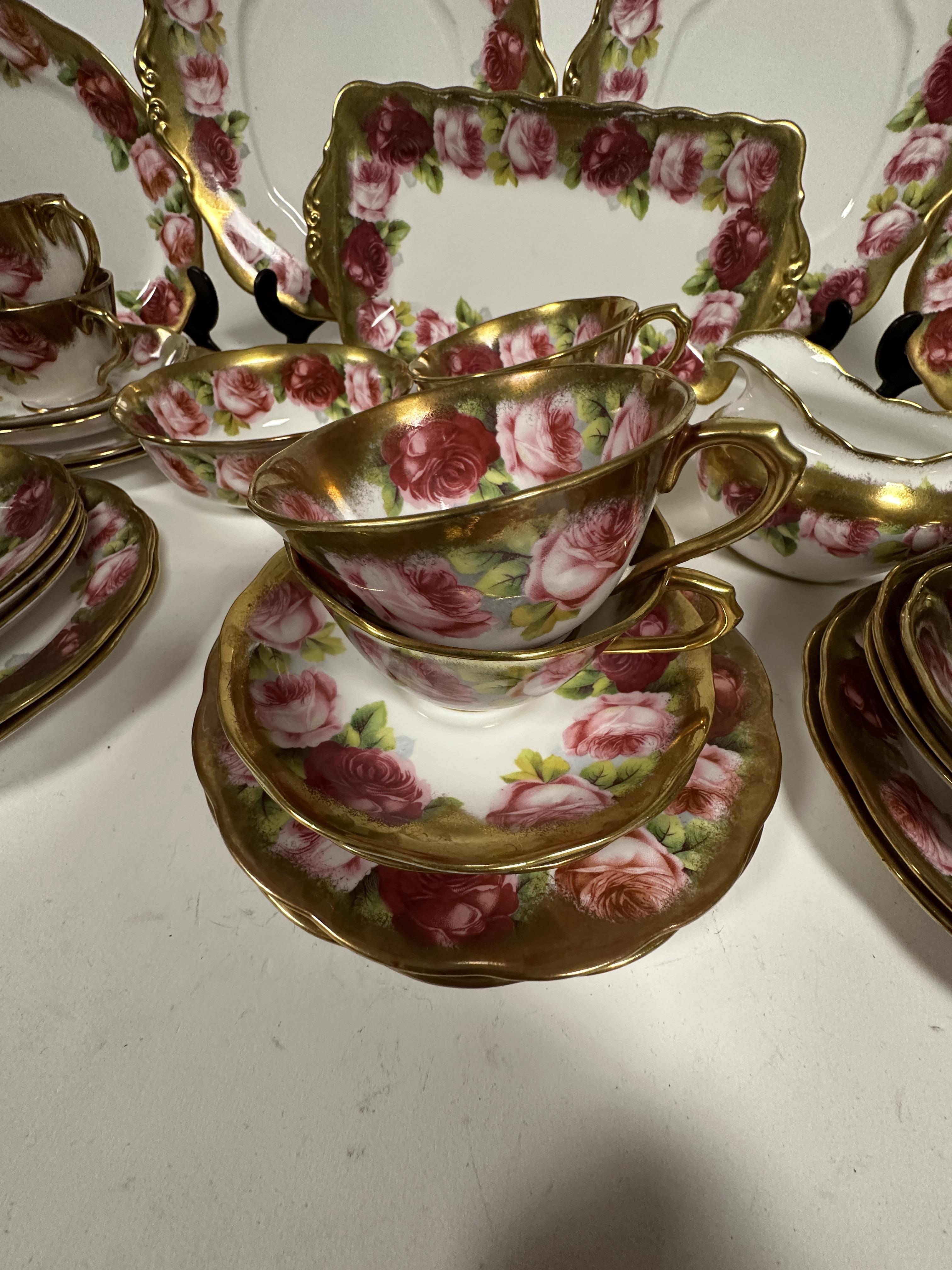 A Royal Albert pink rose and gilt bordered teaset of thirty nine pieces, including two cake - Image 4 of 9