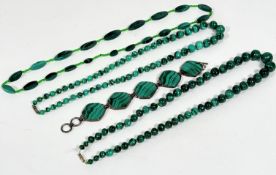 A malachite graduated navette shaped bead necklace with glass bead spacers, (33cm) a malachite