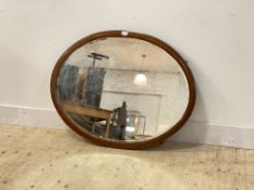 An Edwardian inlaid mahogany framed oval wall hanging mirror, 74cm x 95cm