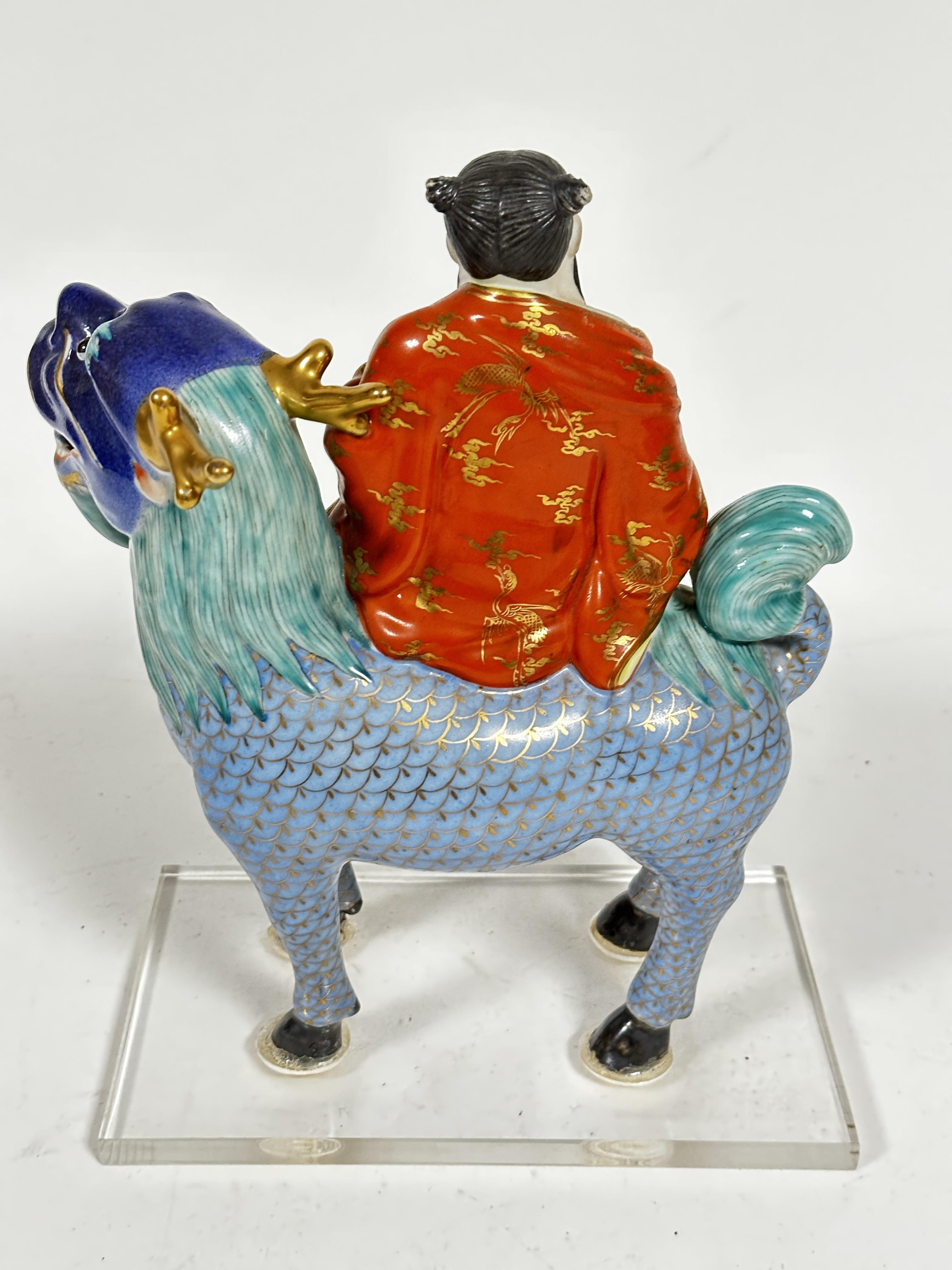 A Japanese porcelain figure of a dignitary with fan, seated on a deer, mounted on plastic base, (7cm - Image 3 of 6
