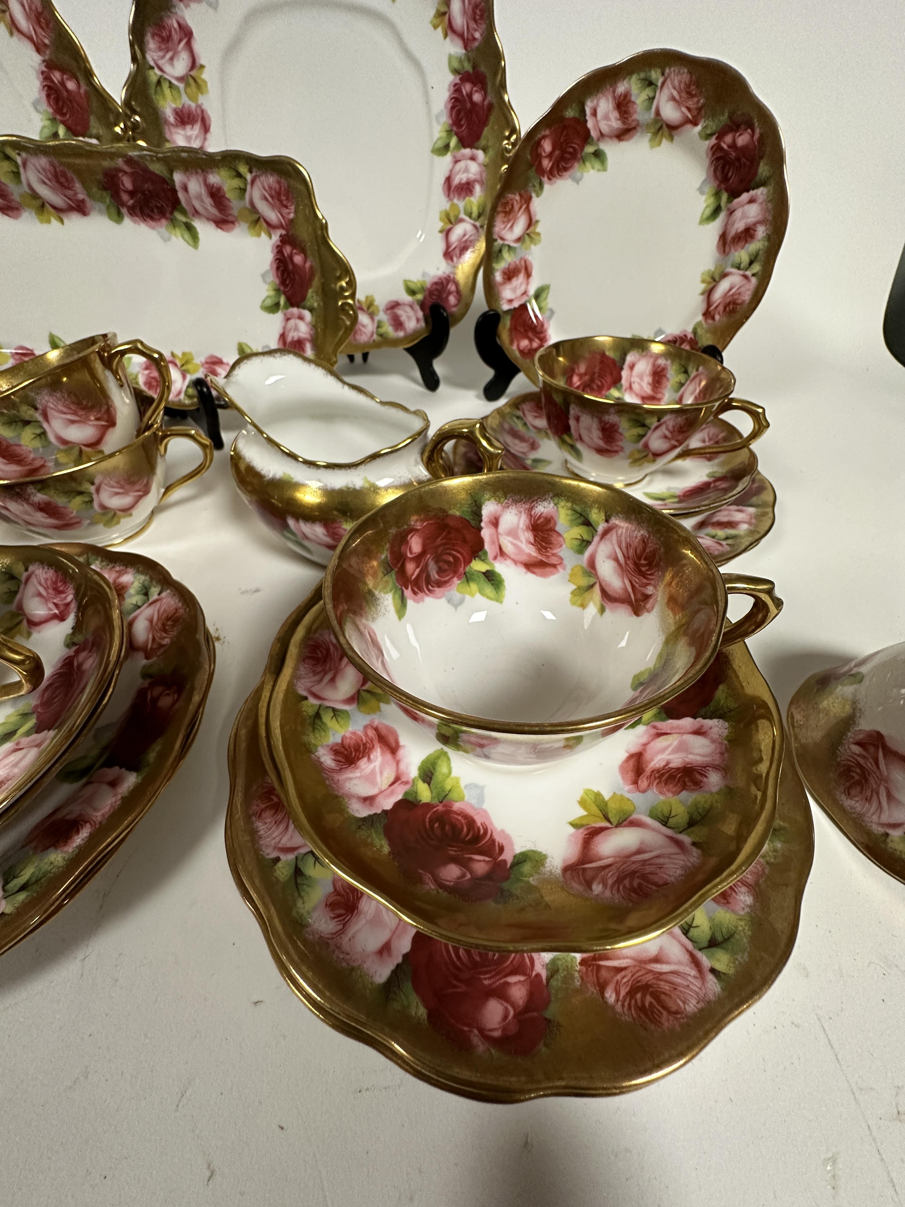 A Royal Albert pink rose and gilt bordered teaset of thirty nine pieces, including two cake - Image 5 of 9