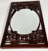 Chinese cherry wood framed wall mirror with oval centre aperture with relief carved scrolling