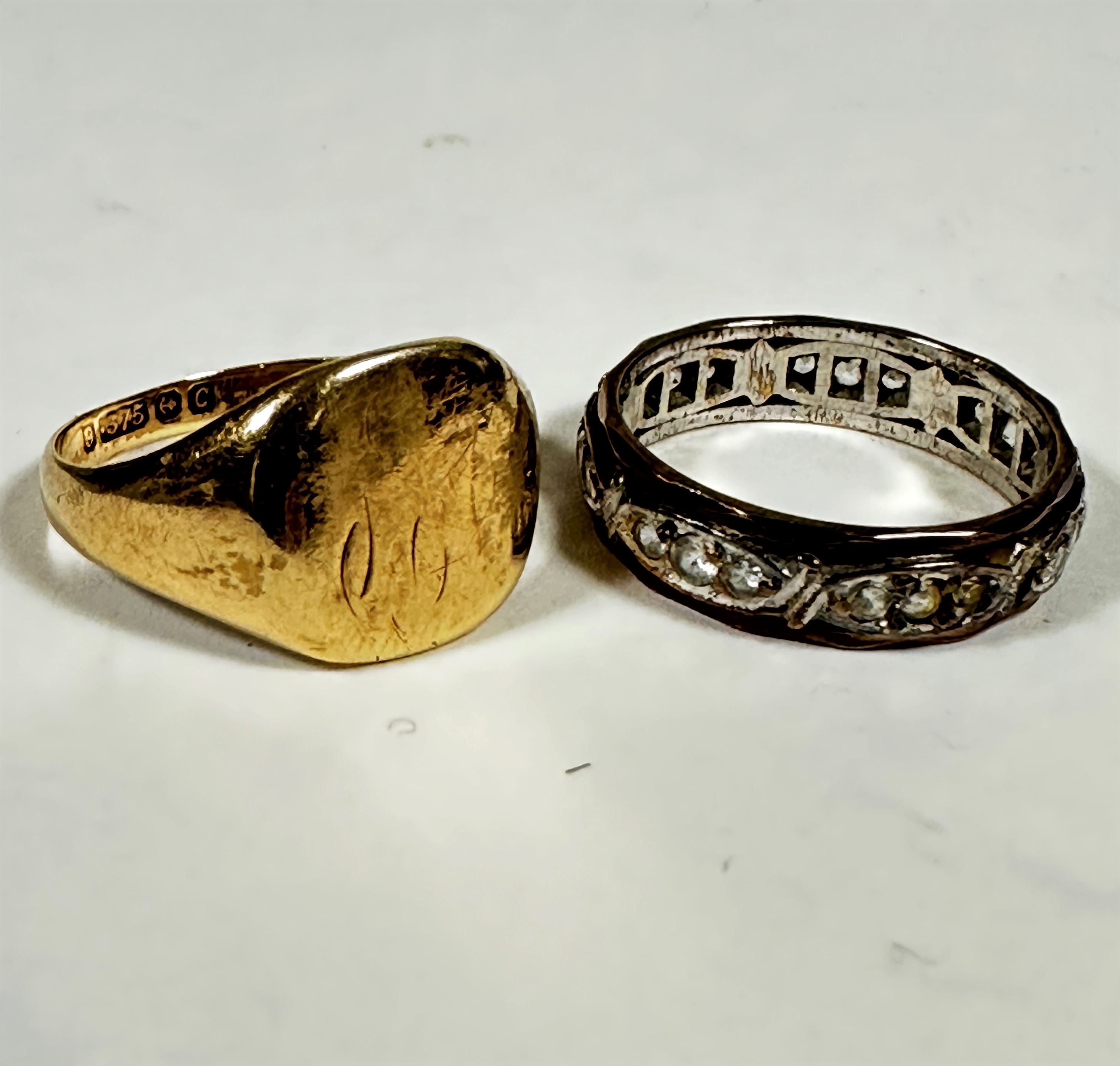 A 9ct gold eternity style ring set paste stones (O) and a 9ct gold signet ring with worn engraved