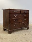 A George III oak chest, mahogany cross banded top and two short and three long graduated drawers,