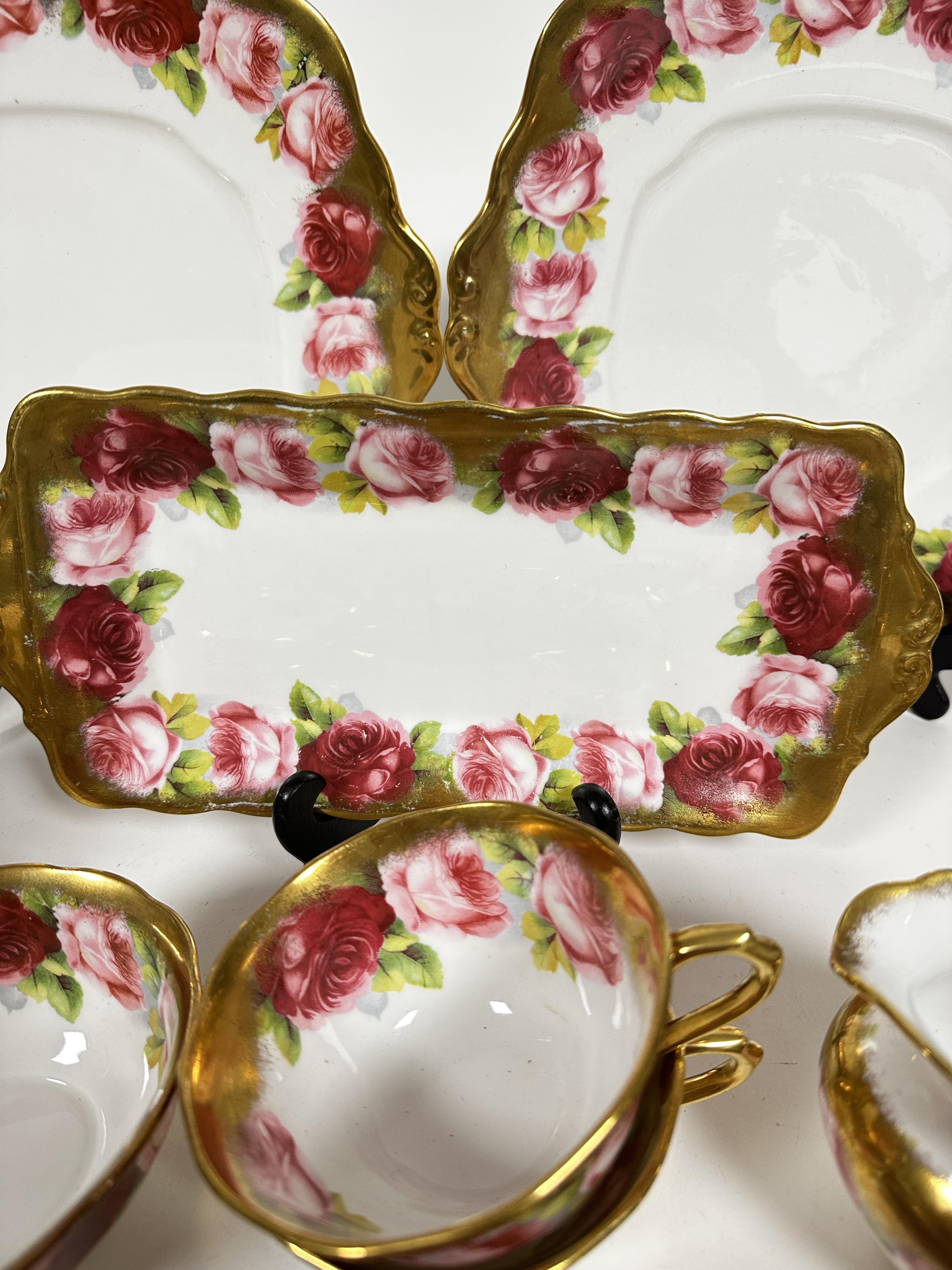 A Royal Albert pink rose and gilt bordered teaset of thirty nine pieces, including two cake - Image 2 of 9