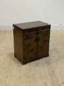 A Chinese style stained hardwood cabinet, fitted with four short and one long drawer, twin