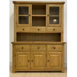 A contemporary oak dresser, the top fitted with open shelf flanked by two glazed cupboards, over