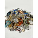 A large collection of costume jewellery including an assortment of metal bangles, gilt chains,