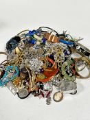 A large collection of costume jewellery including an assortment of metal bangles, gilt chains,