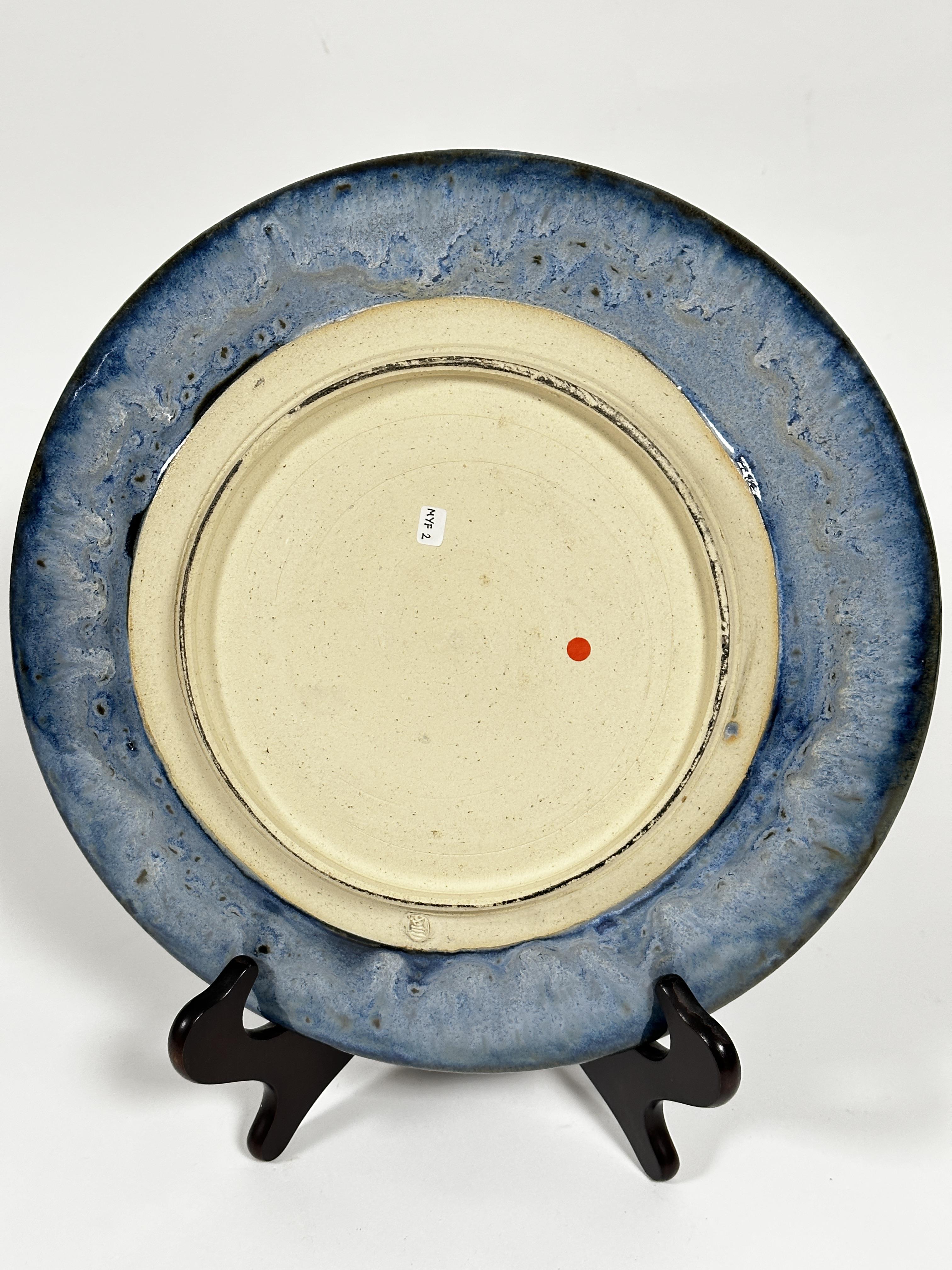 A pottery circular dish decorated with spiralling brown pale blue and turquoise blue glaze, with - Image 3 of 4