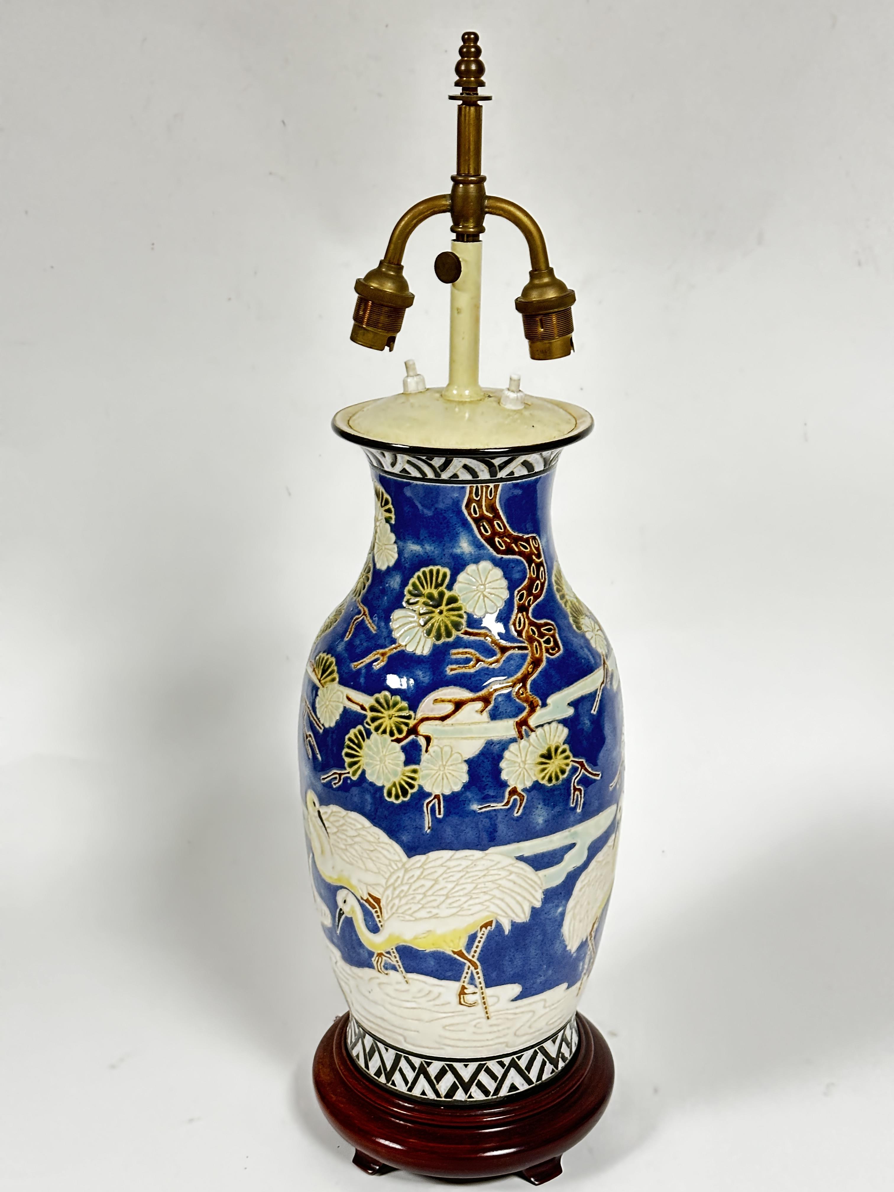 A Japanese baluster vase converted to lamp depicting scenes with cranes and prunis trees, blue