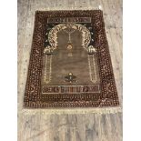 A Persian prayer rug, hand knotted, the field with mihrab within a multi line border 128cm x 92cm