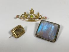 An Edwardian Peridot and seed pearl brooch, stamped 15ct, together with a silver brooch set with