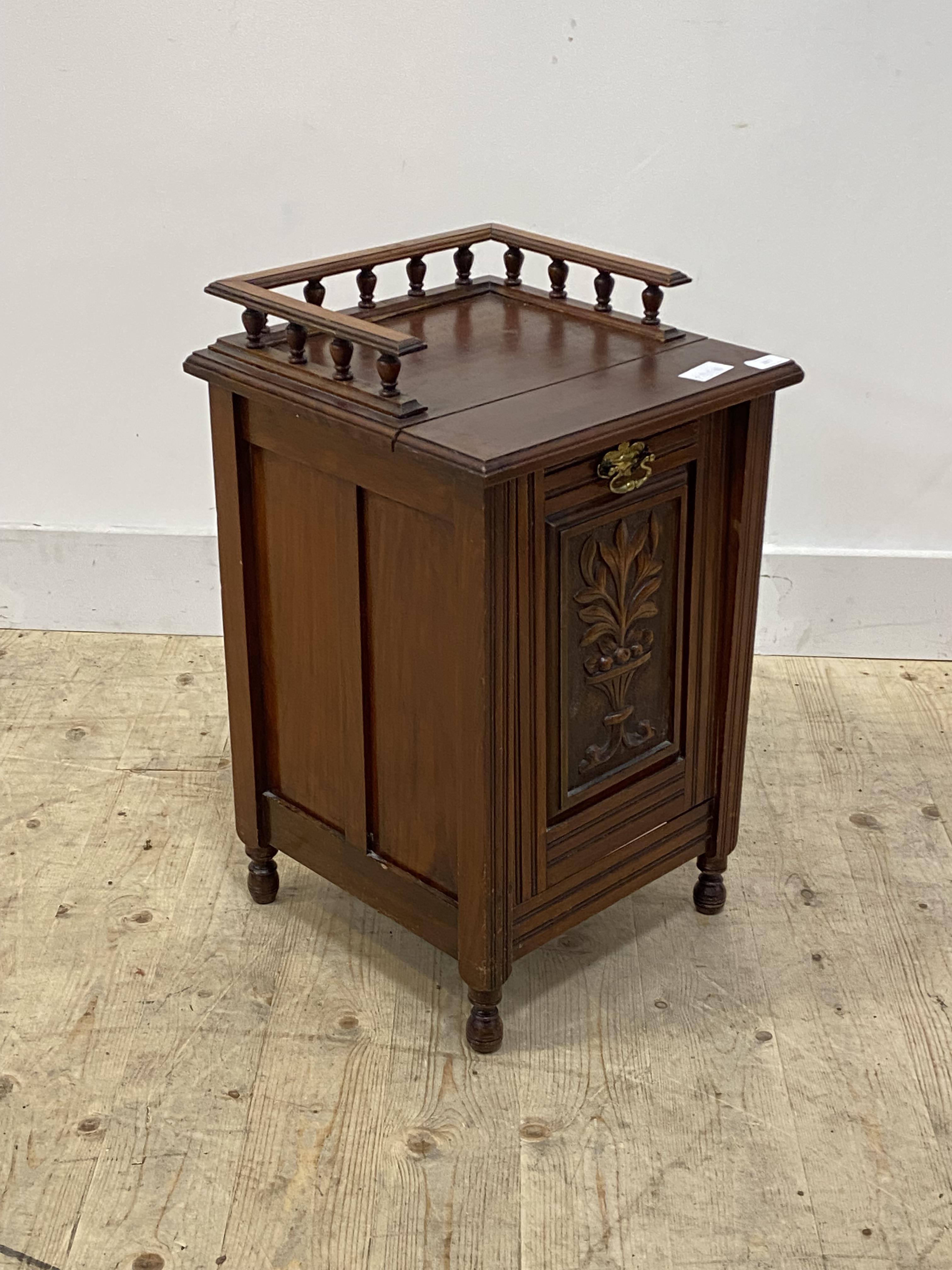 An Edwardian carved walnut coal purdonium, with three quarter galleried top, turned supports, H63cm,