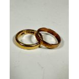 An 18ct gold wedding band (L/M) (5.58g) and a yellow metal wedding band (cut) (M/N) (0.5g) (2)