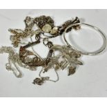 A silver floral drop brooch (6cm), a silver engraved bangle (d.6.5cm), a silver trumpet pendant