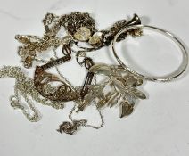 A silver floral drop brooch (6cm), a silver engraved bangle (d.6.5cm), a silver trumpet pendant