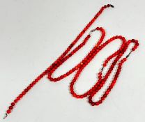 A collection of four red dyed coral bead necklaces, (L 42cm, beads d 7cm approximately)